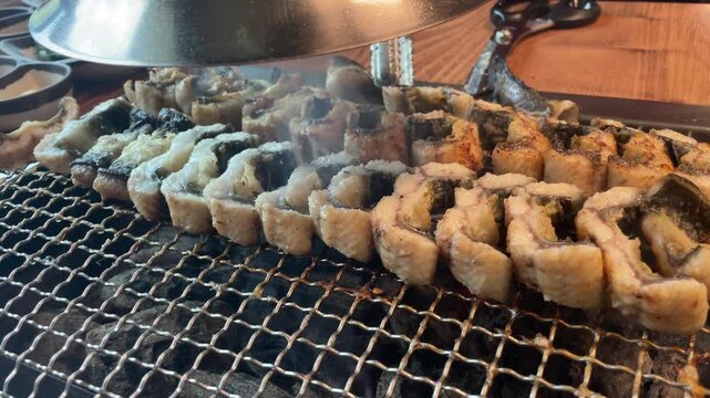 Grilled eel on charcoal fire &ndash; Korean BBQ cooking with smoke and sizzling seafood 4K
