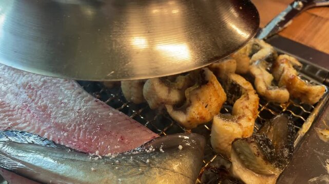 Grilled eel on charcoal fire &ndash; Korean BBQ cooking with smoke and sizzling seafood 4K
