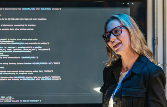 Female Software Engineer Presenting Code During Technical Meeting
