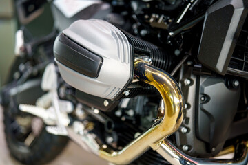 Fototapeta premium Detailing the powerful engine and golden exhaust pipes of a modern touring Motorcycle