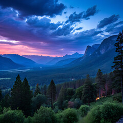 Obraz premium Vibrant sunset paints the sky over a lush valley, mountains, and trees in a scenic landscape.