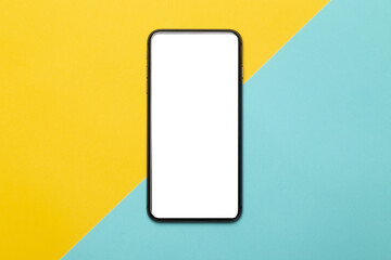 Black smartphone with blank screen mockup isolated on yellow and blue background. Clipping path.