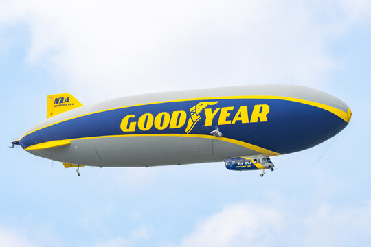 Goodyear Blimp Wingfoot Airship in Blue and Yellow Livery Flying Overhead