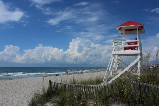 Sun-soaked Summer Day at Wrightsville Beach: Lifeguard Tower Overlooking Racked Chairs in North Carolina