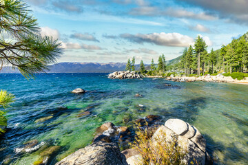 Sand Harbor State Park at Lake Tahoe Nevada USA with sandy beach turquoise water pine trees and Sierra Nevada mountains scenic summer landscape peaceful lakeshore view with natural beauty clear sky