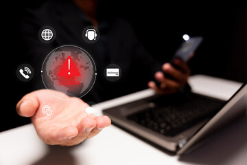 A hand is presented with digital icons displaying alerts, symbolizing communication and technology risks, against a backdrop of a laptop.