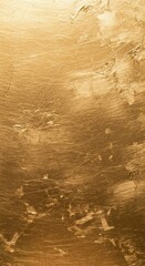 Naklejka premium Golden textured surface with swirling patterns and varying shades beneath bright light