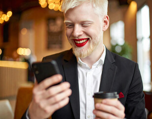 Gay businessman using mobile phone in restaurant
