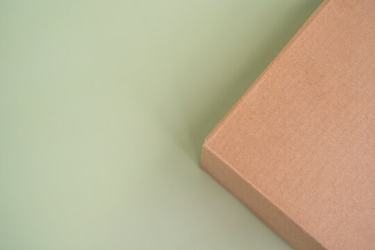 Mock-up of recycled eco friendly cardboard box, product and paracel packaging isolated on green background. Horizontal orientation with negative space for text