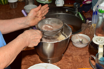 Add cocoa powder through a sieve into the dough in the bowl of a food processor.