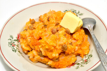 Pumpkin porridge with rice and raisins in a plate.