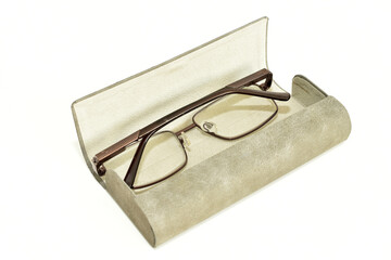 Glasses in a case made of light material on a white background.
