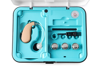 Hearing aid and accessories in box isolated on white, top view