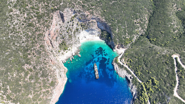 Aerial drone of scenic rocky tropical seascape with white steep limestone cliffs creating a blue lagoon with sea caves and turquoise crystal clear beaches visited by luxury yachts and sailboats - Powered by Adobe