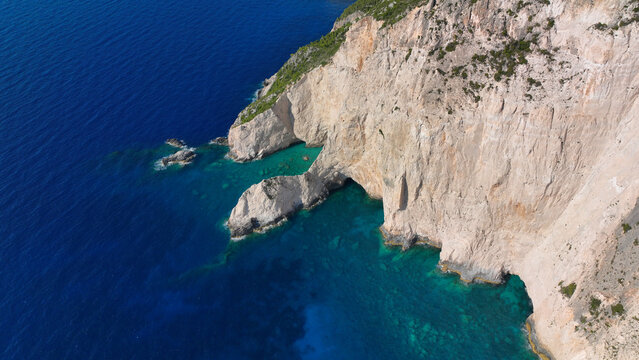 Aerial drone of scenic rocky tropical seascape with white steep limestone cliffs creating a blue lagoon with sea caves and turquoise crystal clear beaches visited by luxury yachts and sailboats - Powered by Adobe