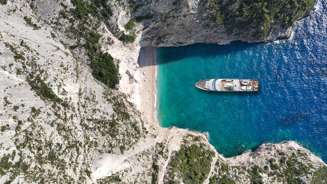 Aerial drone ultra wide panoramic top down photo with copy space of luxury yacht anchored in tropical exotic island with crystal clear turquoise sea