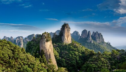 Fototapeta premium a unique rock formation stands tall amidst lush green forests revealing the vastness of the mountainous terrain