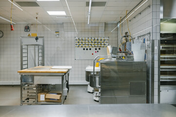 Industrial kitchen with stainless steel equipment and tiled walls