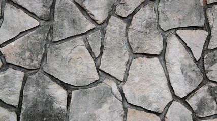 Natural limestone texture wall . Close-up view of irregular, light beige and off-white stones background