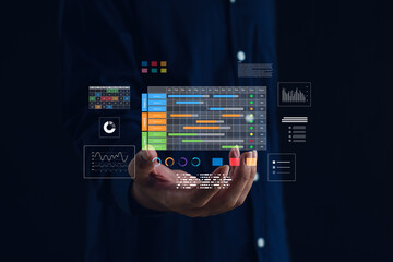 Data analytics and project management dashboard concept. Hand holding virtual digital interface with charts, graphs, timelines representing business strategy, technology, and performance tracking.