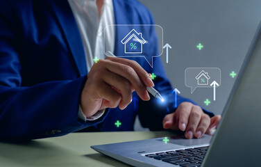 businessman using a digital pen to analyze real estate investment, property value, and mortgage rates with futuristic icons, representing financial growth, fintech, and modern business technology.