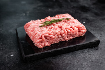 Raw ground pork meat, mincemeat. black background. top view