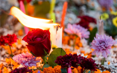 Christian community offer flowers and light candles for their departed family members on 