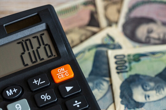Japan money. Japanese yen and a calculator with the year 2026. Financial and economic concept. close up, Business background