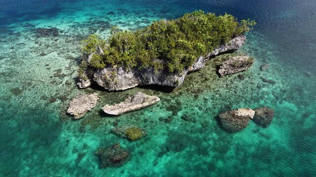 Raja Ampat. Indonesia. Aerial view of lush tropical islands and turquoise lagoons in showcasing pristine nature and coral-rich waters.	