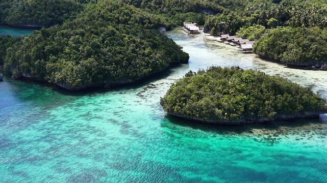 Raja Ampat. Indonesia. Aerial view of lush tropical islands and turquoise lagoons in showcasing pristine nature and coral-rich waters.	