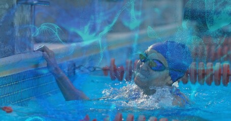 Reaching swimmer with swim cap touching competition pool wall after lap, with red lane dividers