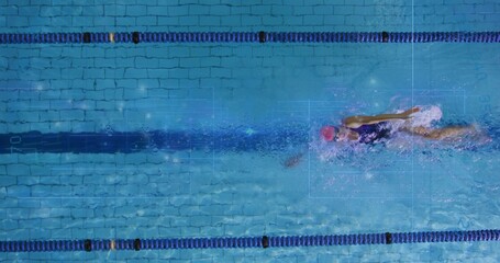 Swimming woman performing front crawl in lap pool, with lane dividers, stripe, pink cap and goggles