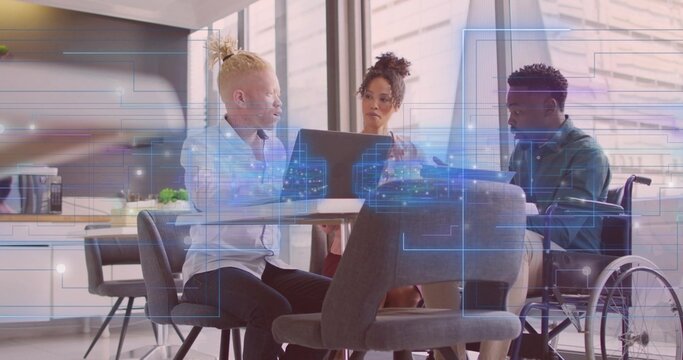 Collaborating wheelchair user and two colleagues using laptop in kitchen with digital overlays - Powered by Adobe