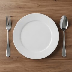 Simple place setting with white plate fork and spoon isolated on white background