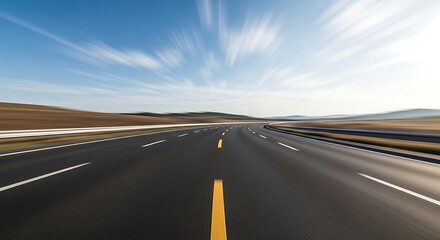 Open asphalt highway stretches toward a distant horizon under streaks of white clouds
