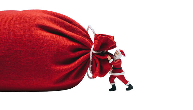 A miniature santa claus struggling to pull a very large red sack against a black background
