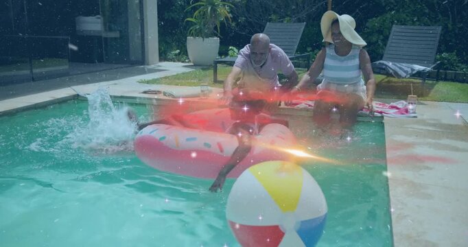 Girl leaning back causing waves as grandparents guiding donut float and showing health pool safety