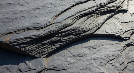 Textured Slate Rock Formation with Layered Sedimentary Patterns.