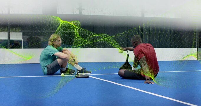 Training pair fetching hopper ball while tracking ball path overlay showing airflow on tennis court