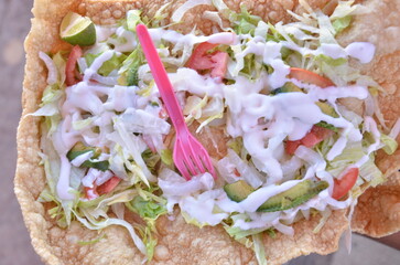 Fresh, vibrant tostada with creamy dressing, avocado, and fresh toppings ready to eat for a delicious meal