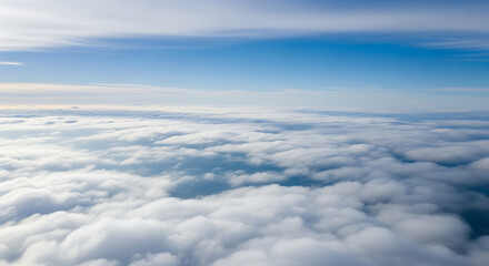 Vast white clouds fill the sky above a blue horizon cloudscape aerial view
