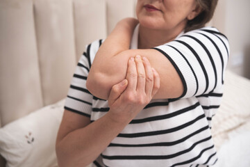 Muscle aches. Adult woman has pain in arm muscles.