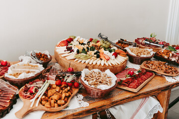 Buffet with a wide assortment of sausages, cheese, pies. Luxury wedding.