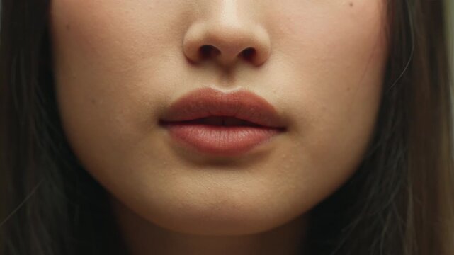 Close up silence hush gesture unrecognizable Asian woman showing secret sign female mouth Chinese girl unknown lady lips silent symbol quite secrecy private confidential information forbidden chatter