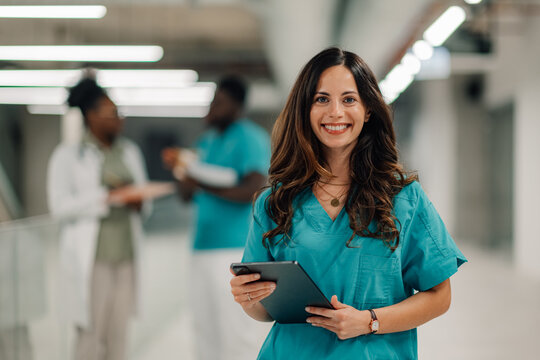 Healthcare professional woman holding tablet in hospital hallway