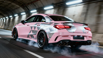 Pink sports car with geometric design speeds through urban tunnel at night