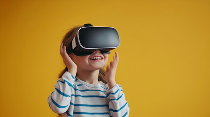 Little child exploring virtual reality on yellow background, wearing VR glasses, smiling, copy space.