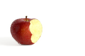 There is a bitten off apple on a white background