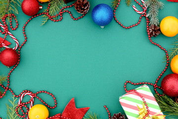 There are many Christmas toys on a green background with space for text.	