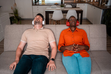 Relaxing couples enjoy music in a cozy living room setting during a peaceful afternoon